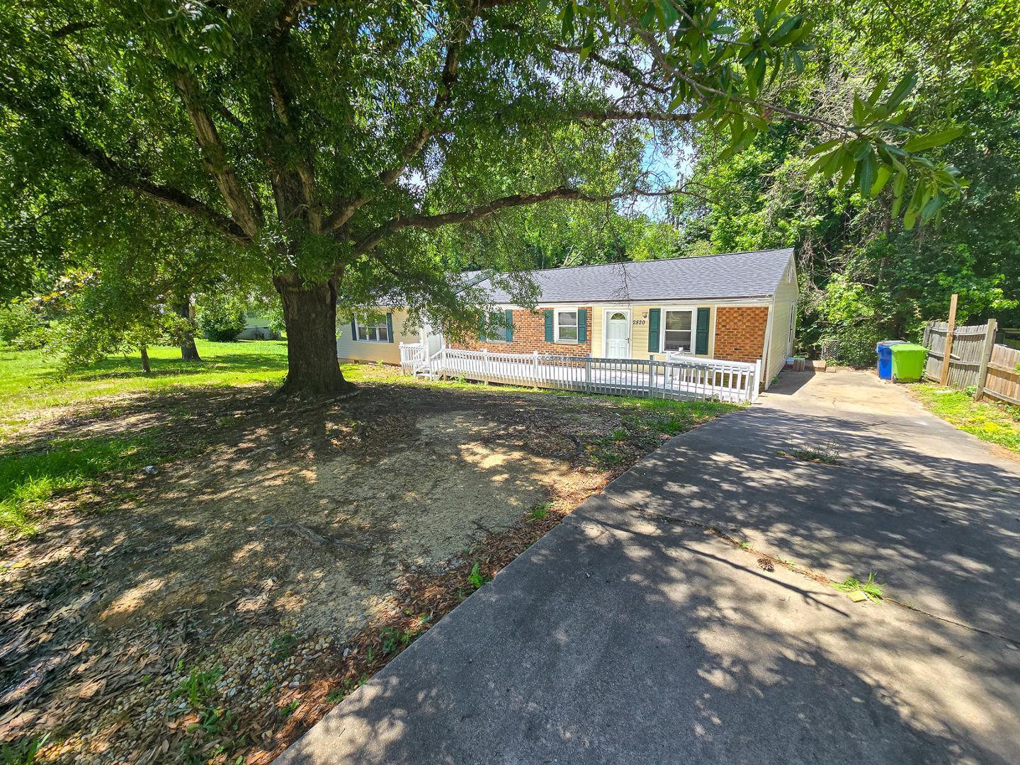 a backyard of a house with table and chairs