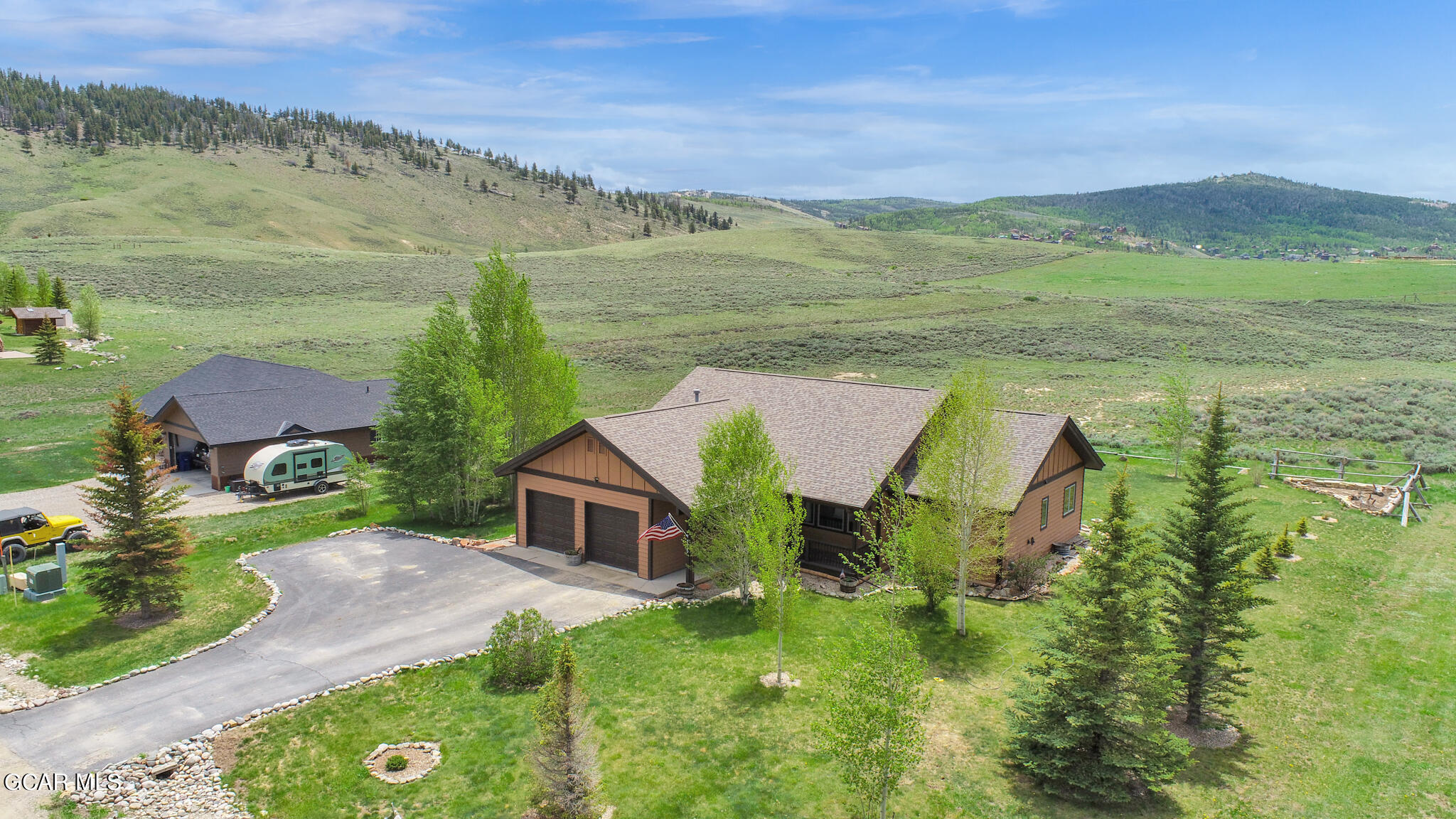 an aerial view of a house with big yard