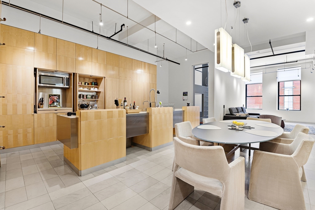 a dining table chairs and a refrigerator