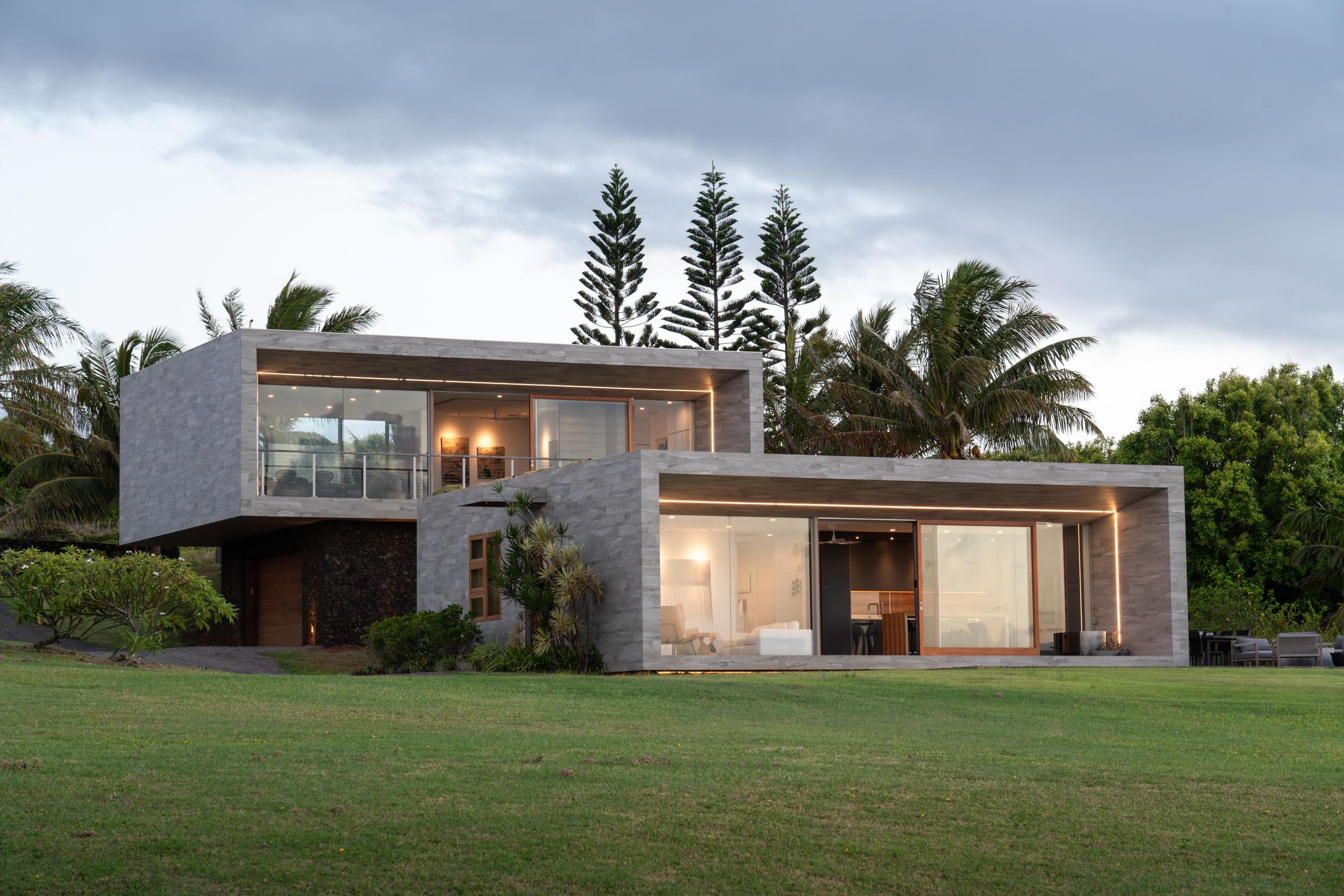 a front view of a house with a garden and yard