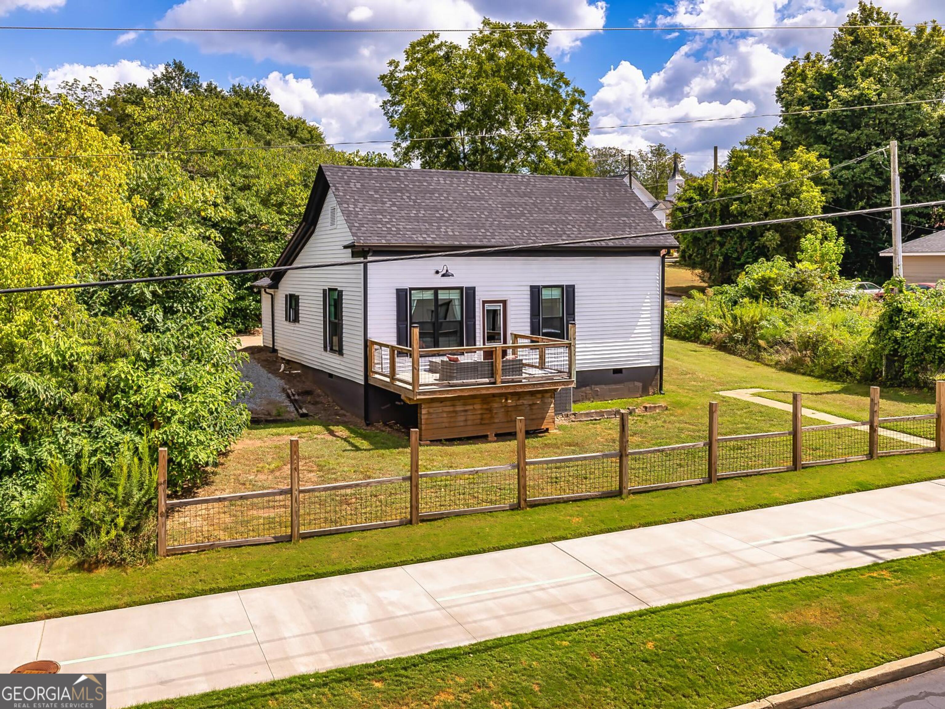 a view of a house with wooden fence