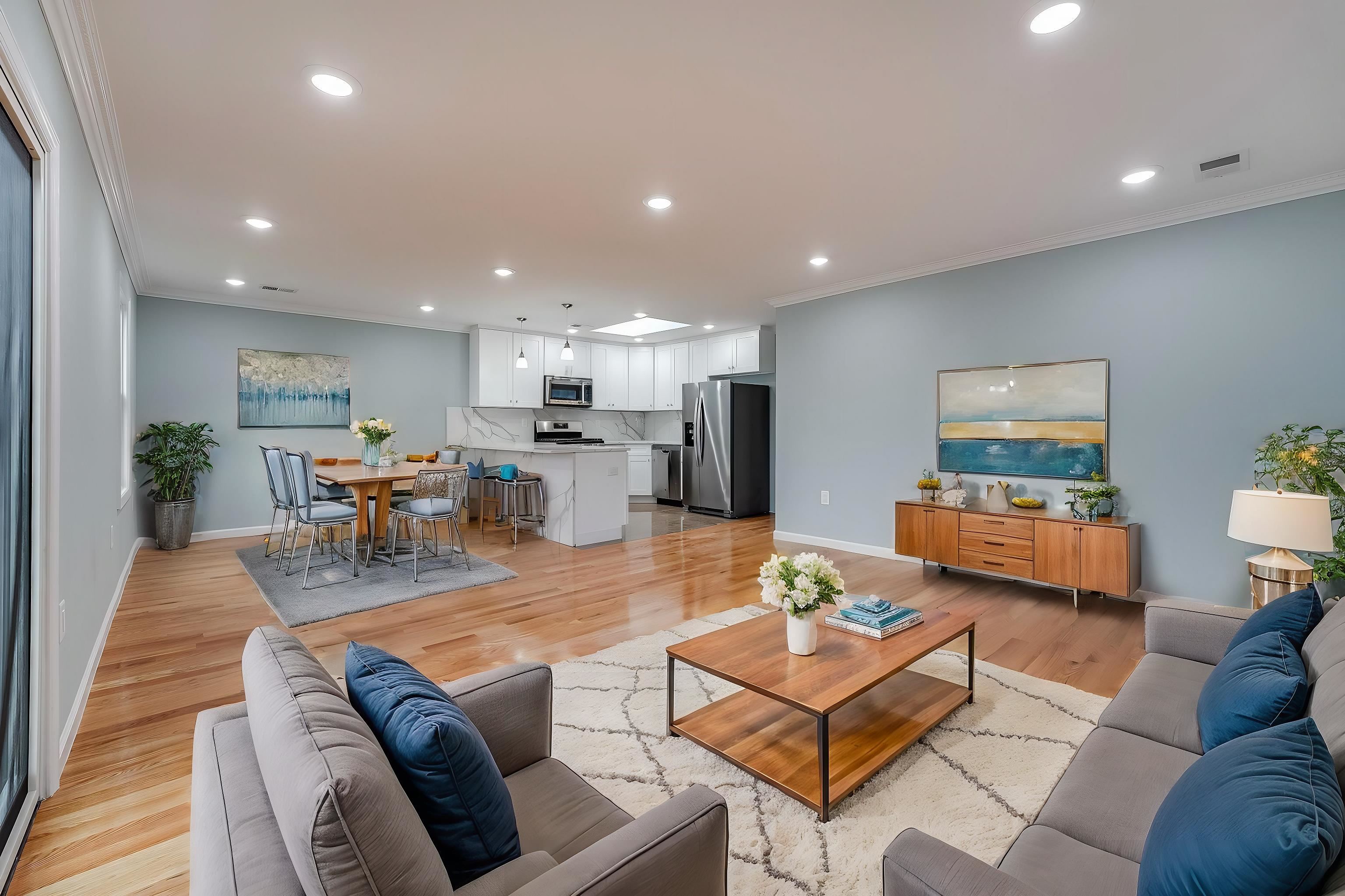 a living room with furniture and kitchen view