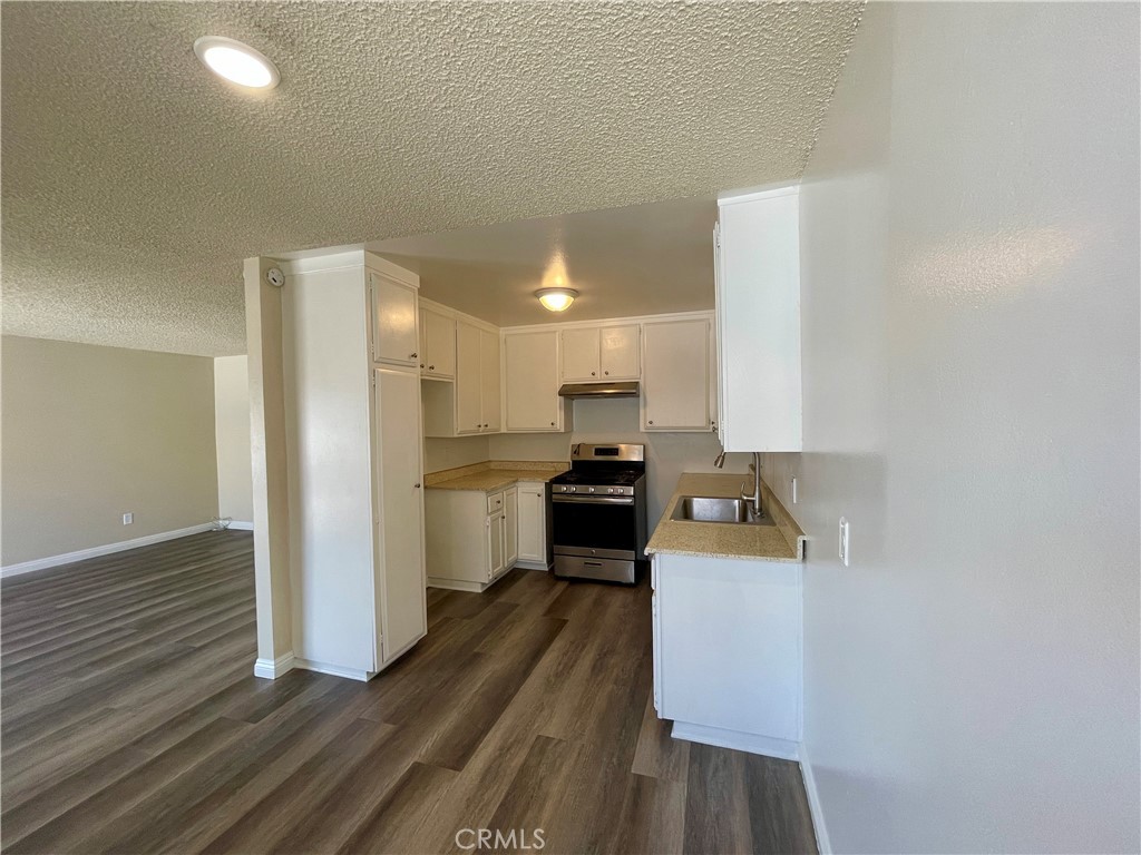 a kitchen with a refrigerator and a stove top oven