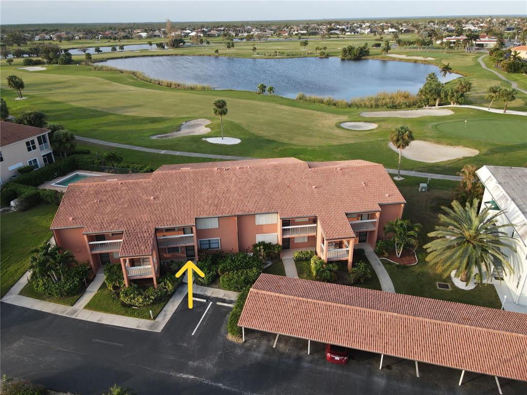 an aerial view of a house with a garden and lake view