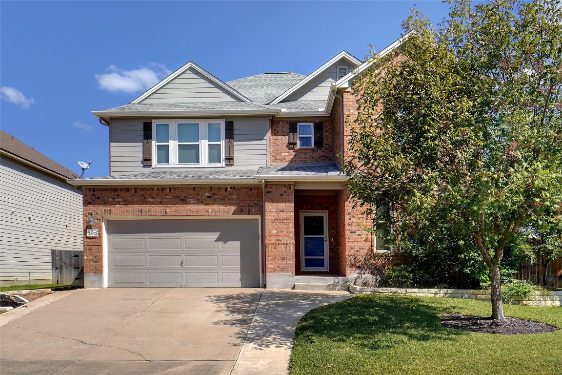 Front of home. Beautifully landscaped with mature trees.