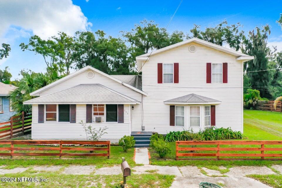 a front view of a house with a yard