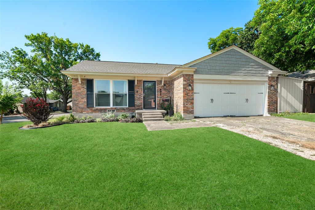 a front view of house with yard and outdoor seating