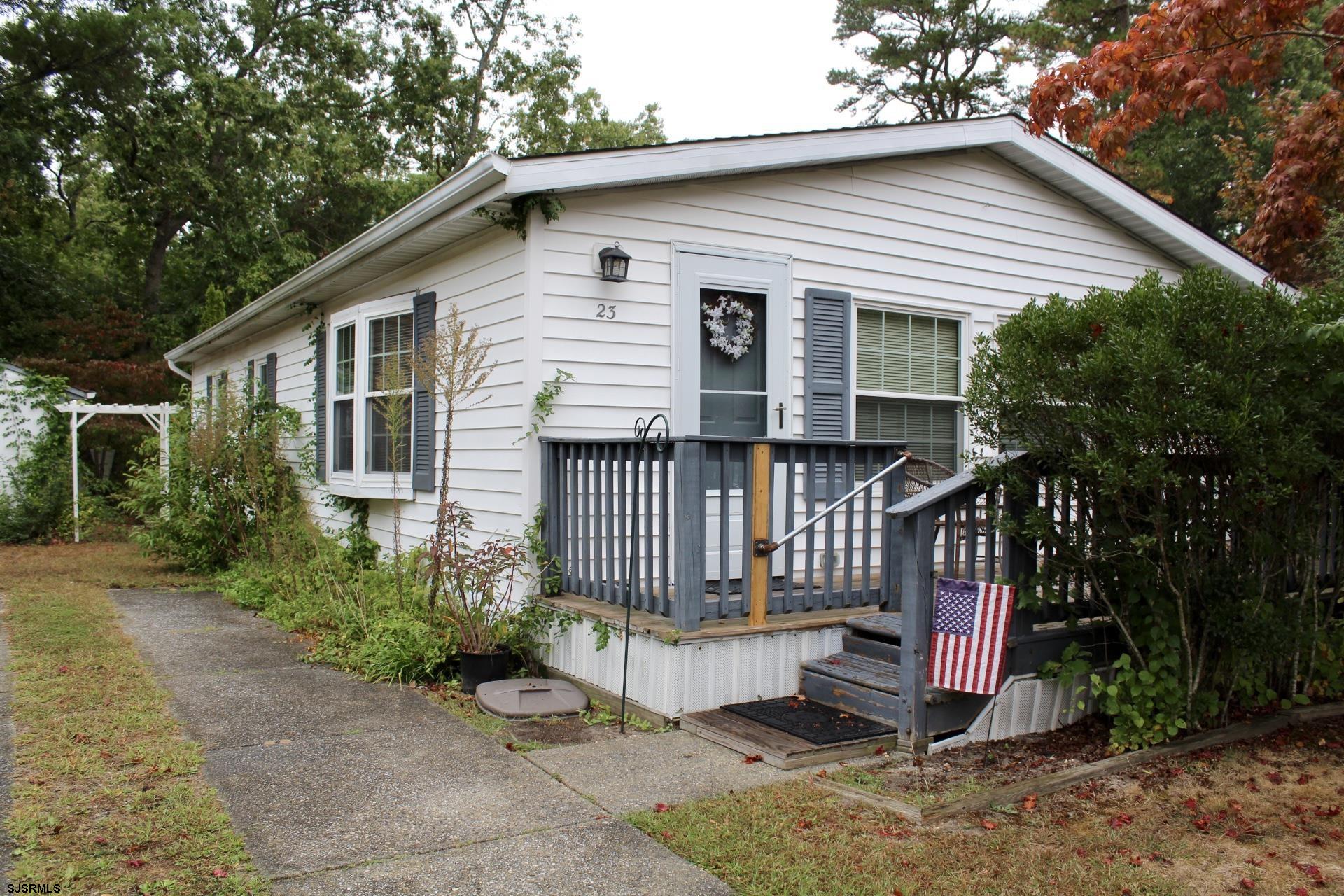 a view of a house with a yard and plants