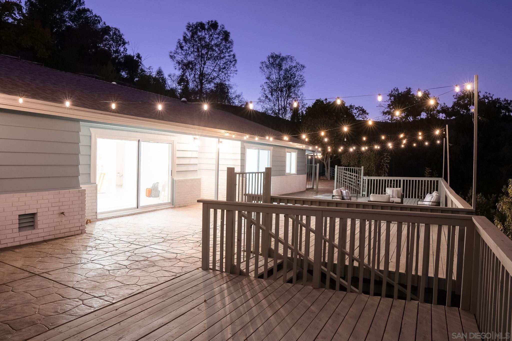 a view of backyard with a deck and wooden floor