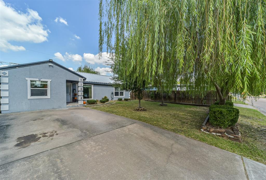 a view of a house with a tree and a yard