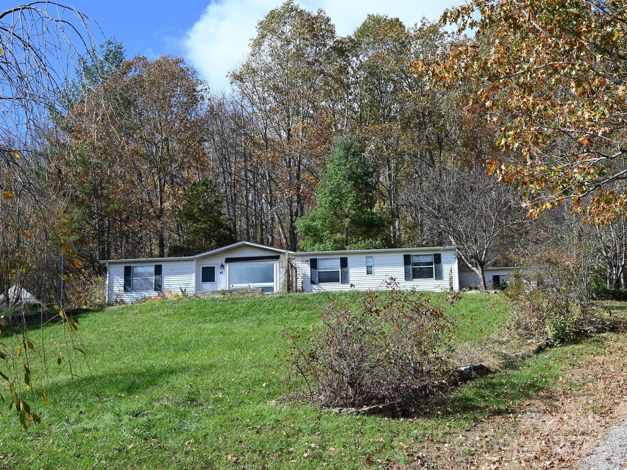 a house with lots of trees in the background