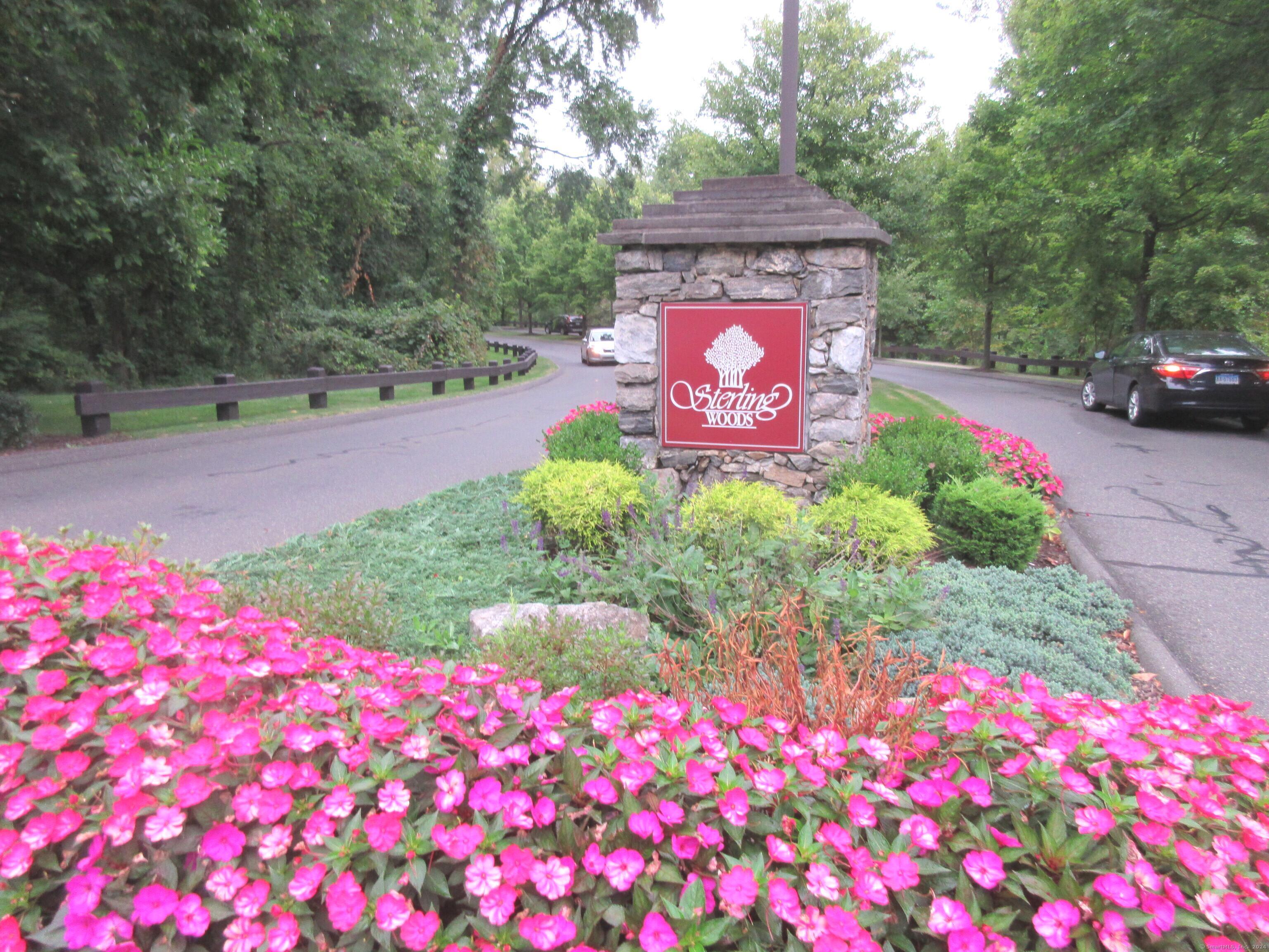 a street sign that is sitting in front of flowers