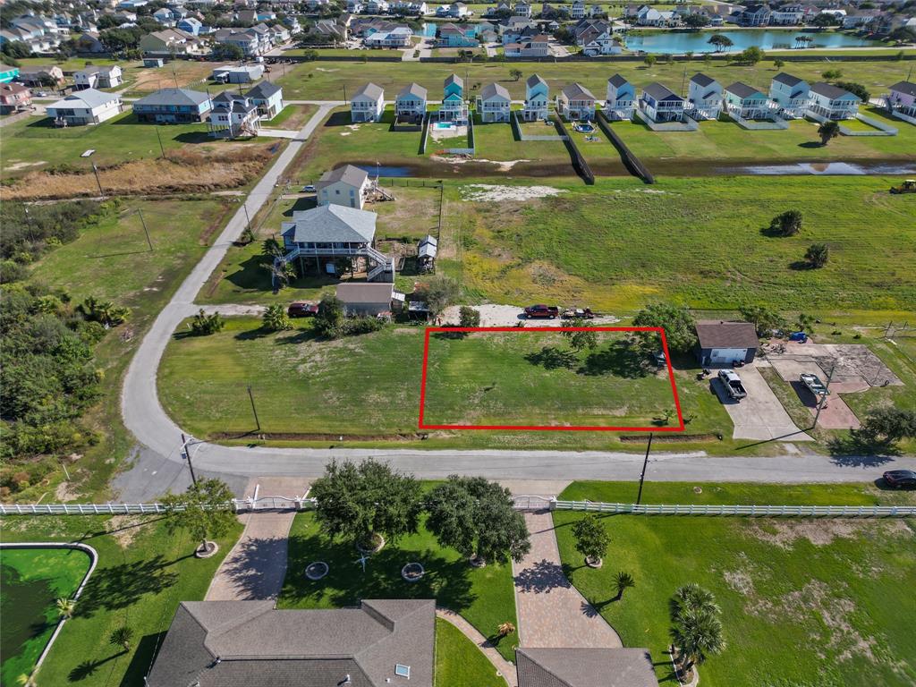 an aerial view of a house with a garden and lake view