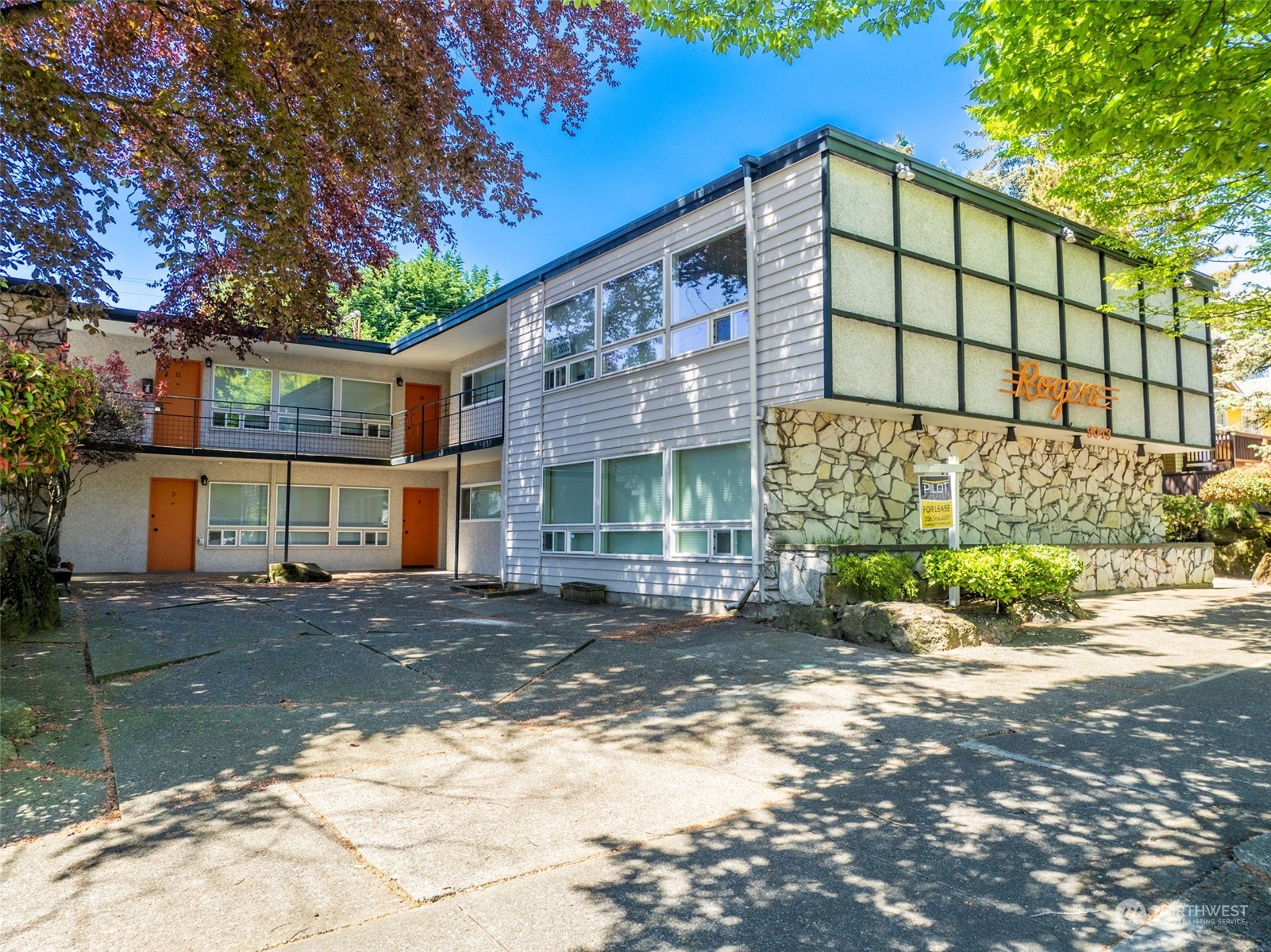 a front view of a house with a garden and outdoor seating