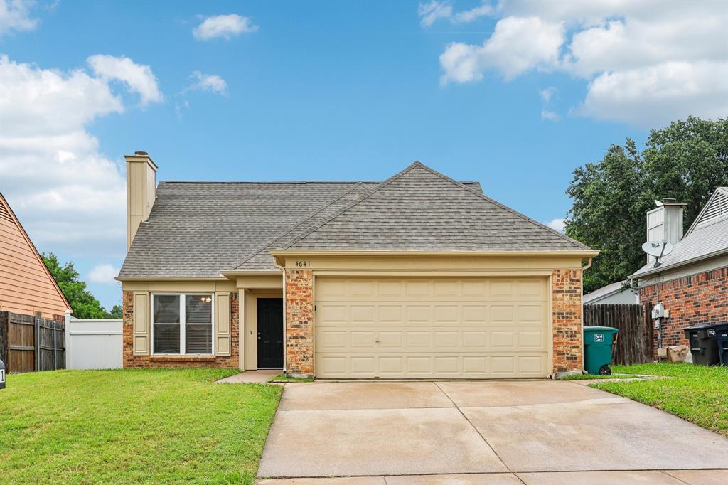 a view of a house with a yard and garage