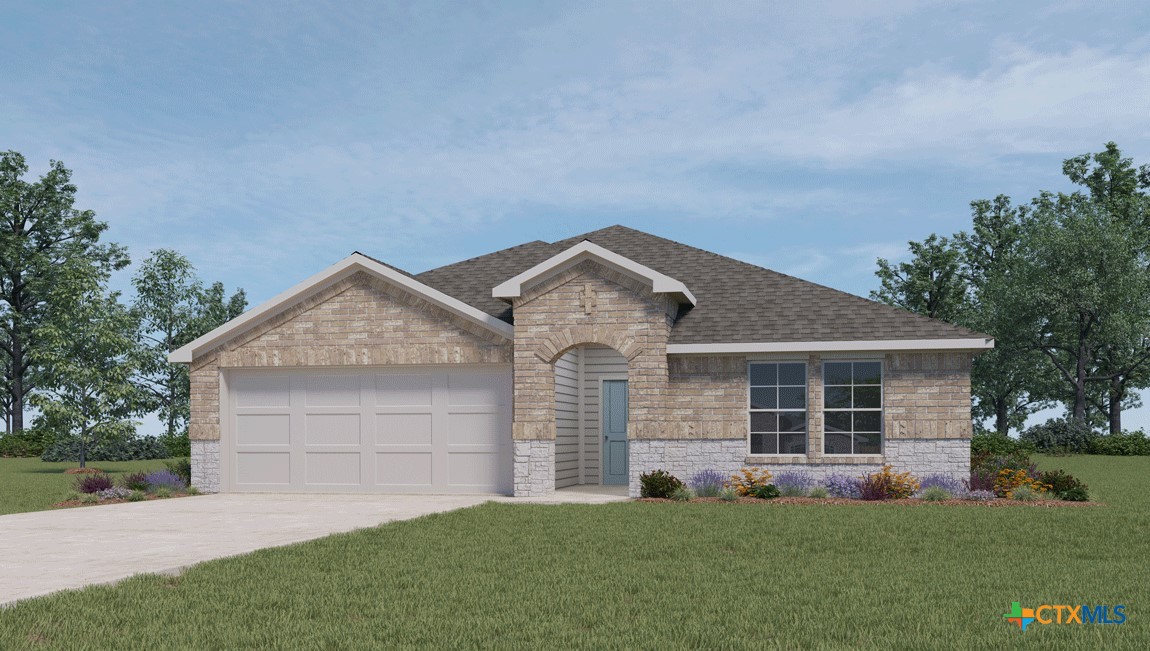 front view of a house with a yard and garage