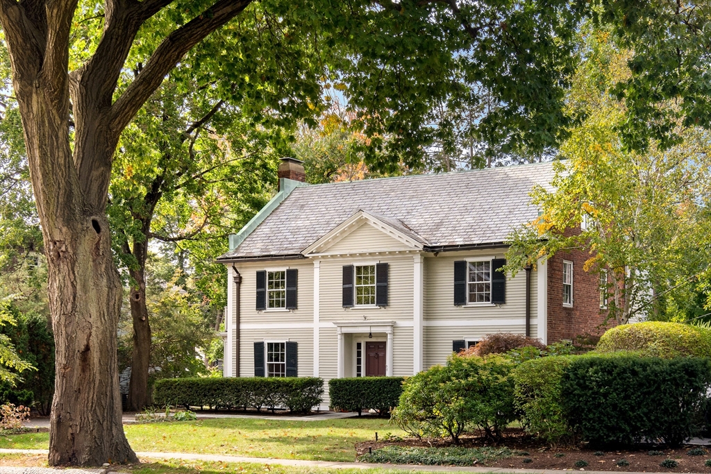 a front view of a house with a garden