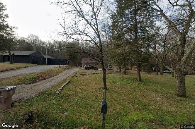 a view of a yard with tree s