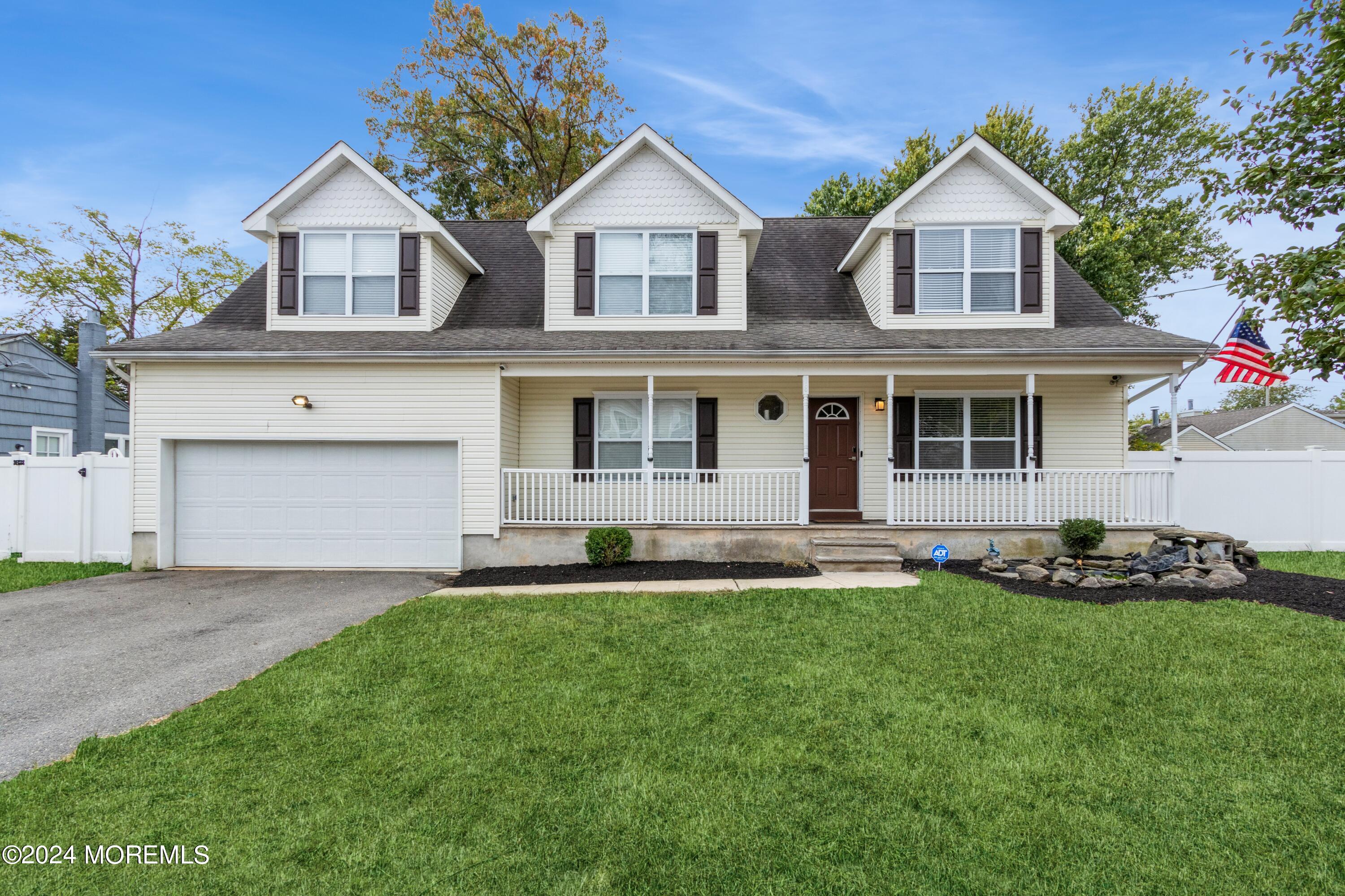 a front view of a house with a garden and yard