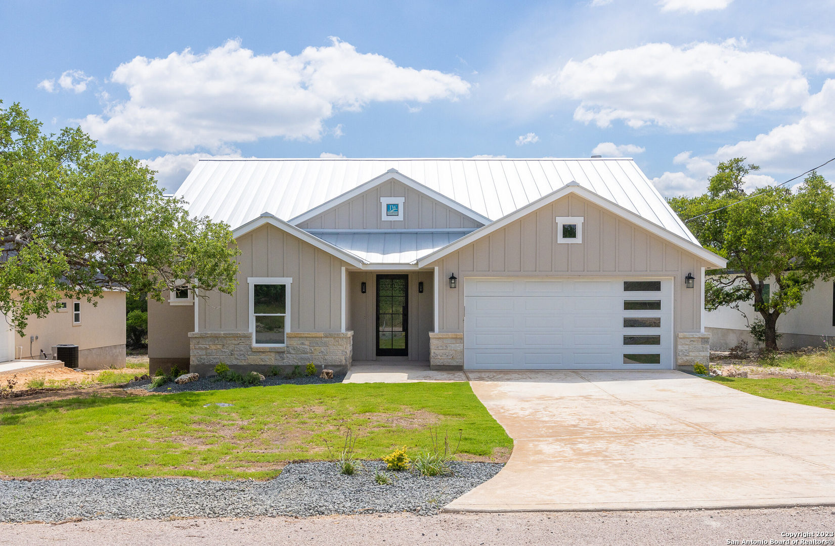 a front view of house with yard outdoor seating and barbeque oven