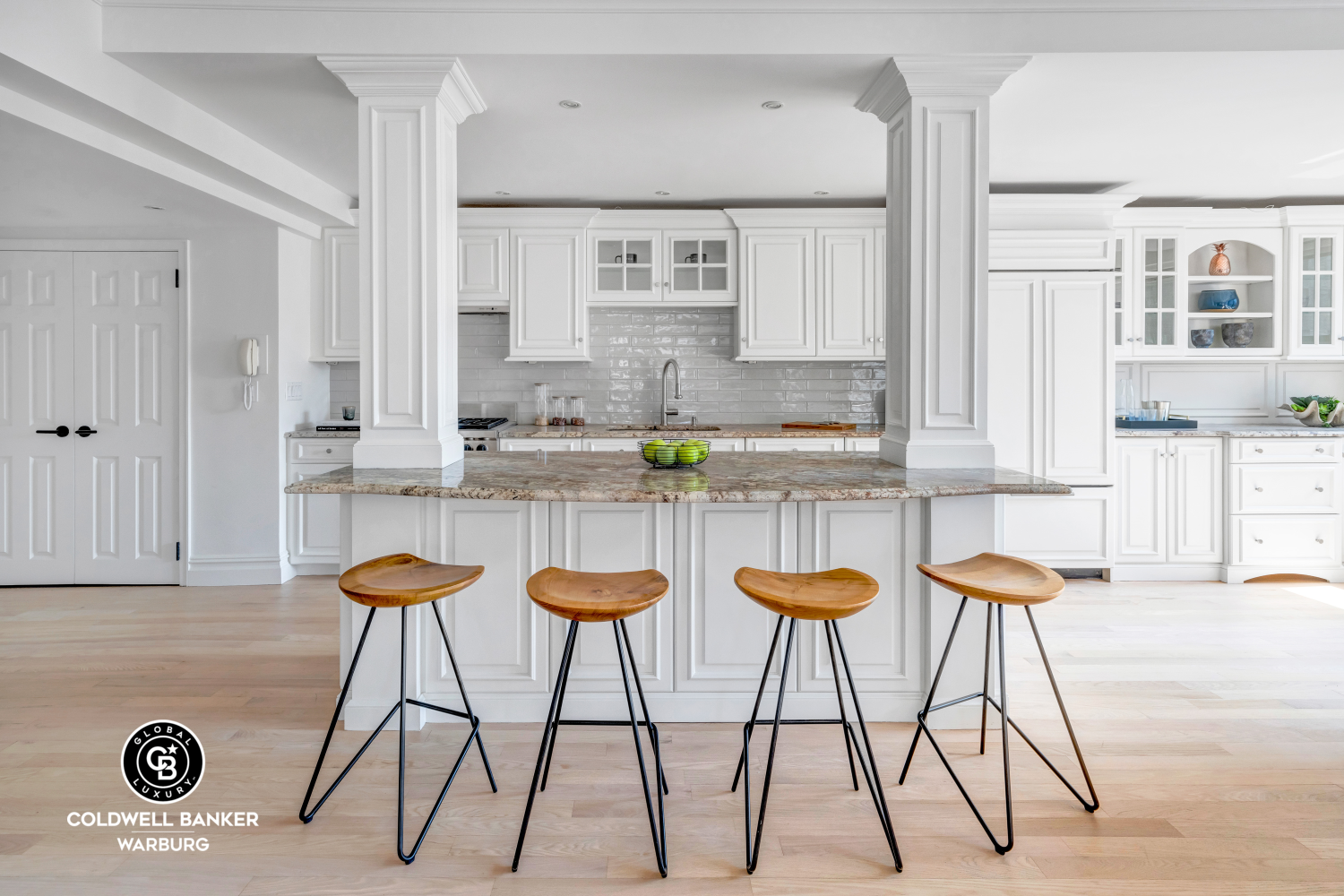 a kitchen with a sink and chairs in it