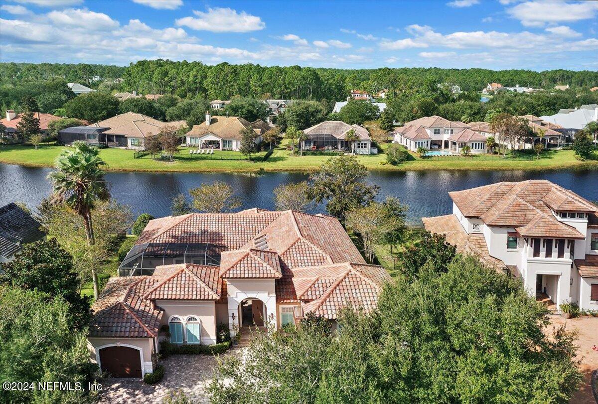 an aerial view of a house with a lake view