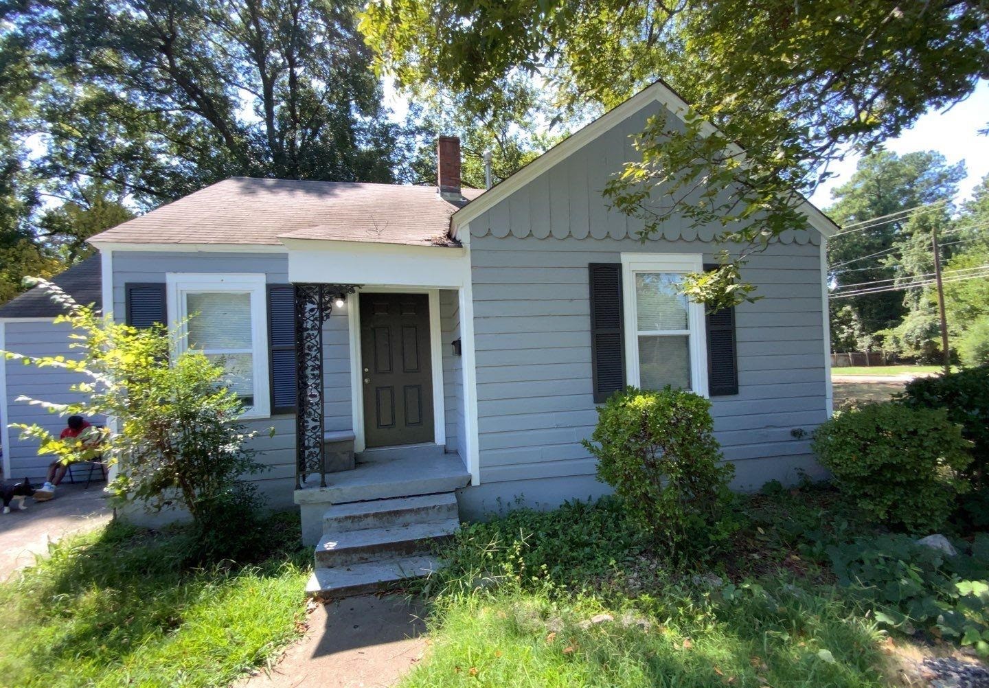 a front view of a house with a garden