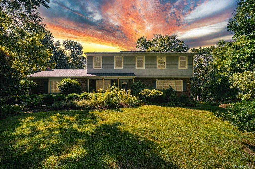 View of front of house featuring a yard & drivway