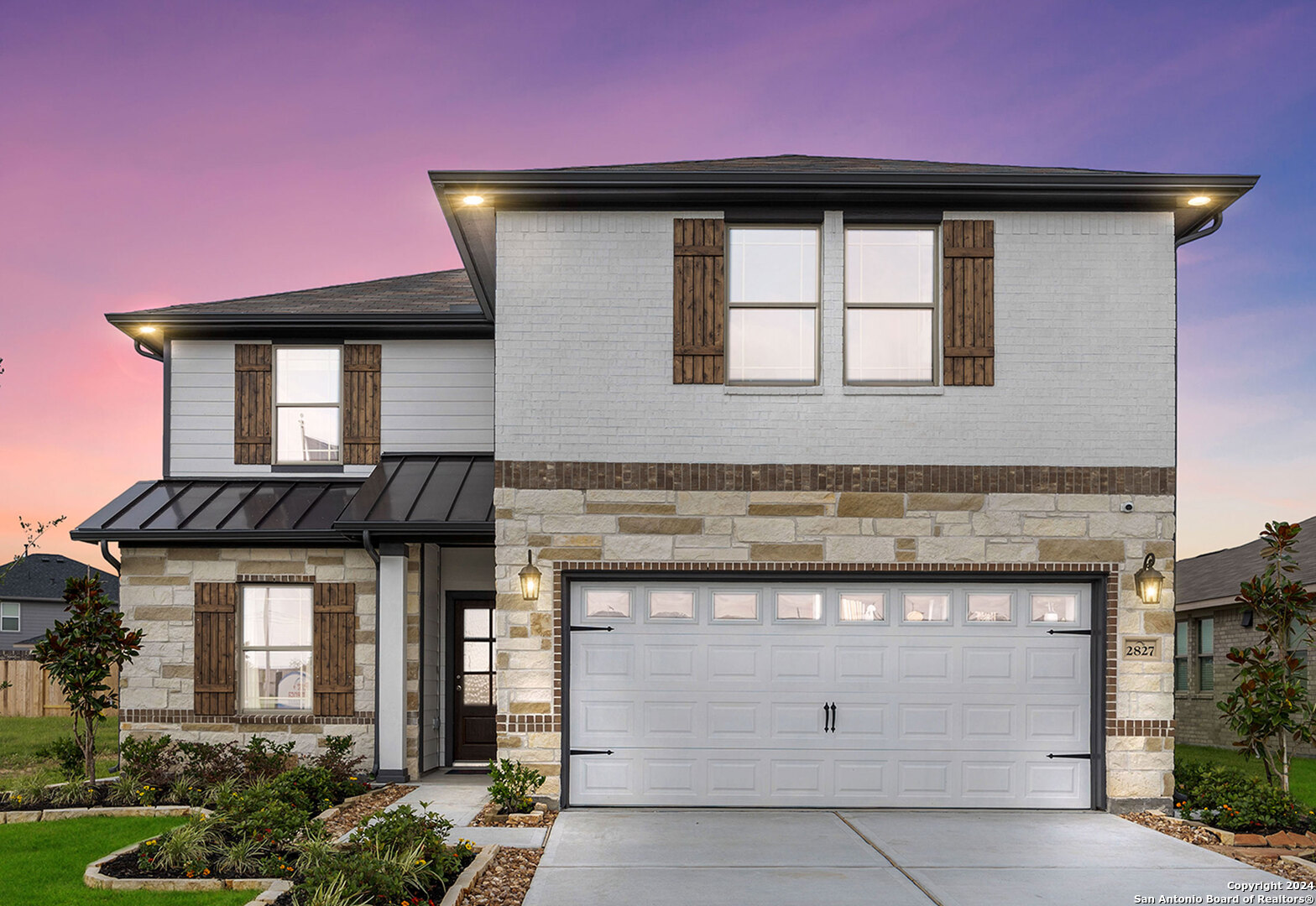 a front view of a house with garage