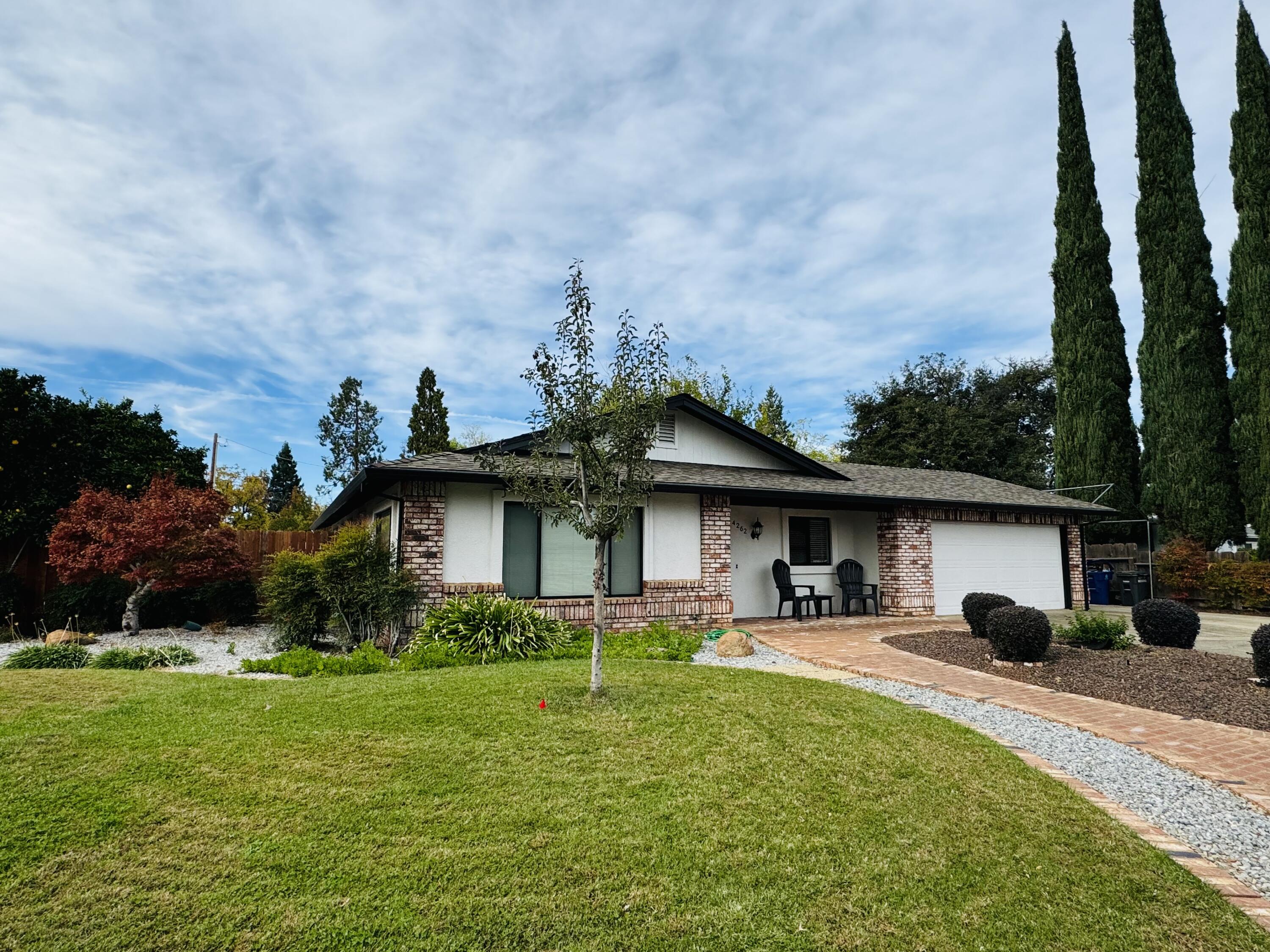 a front view of a house with a garden