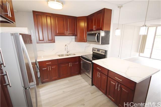 a kitchen with a sink stove and refrigerator