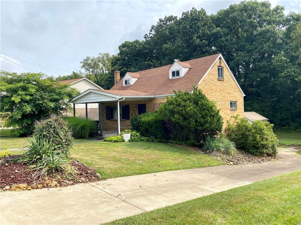 a view of a house with garden and yard