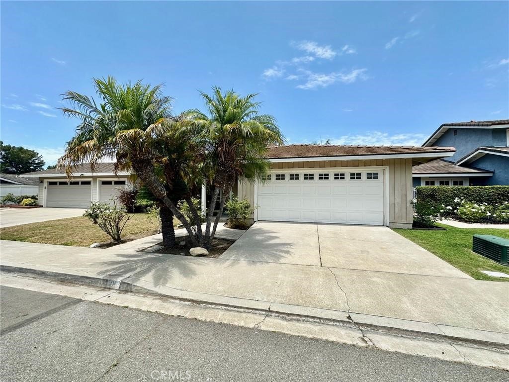 a view of a house with a yard and garage