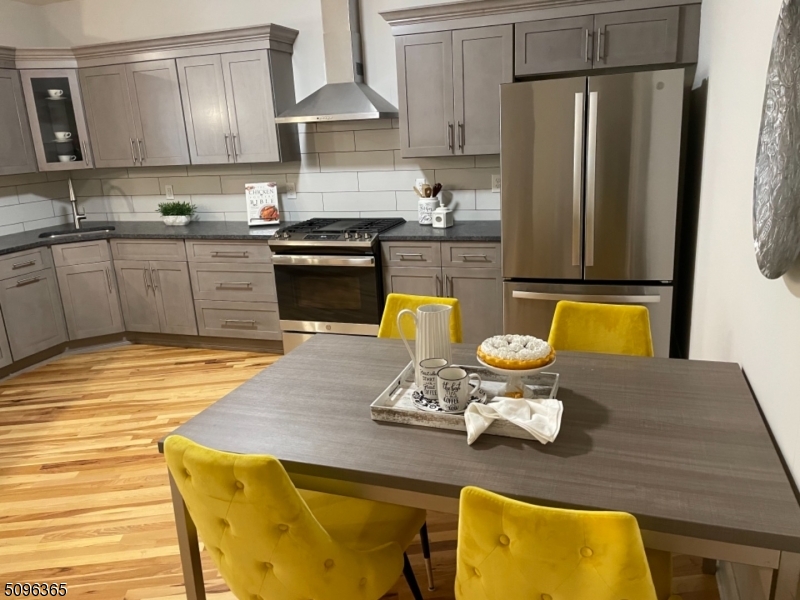 a kitchen with a sink a stove and wooden cabinets