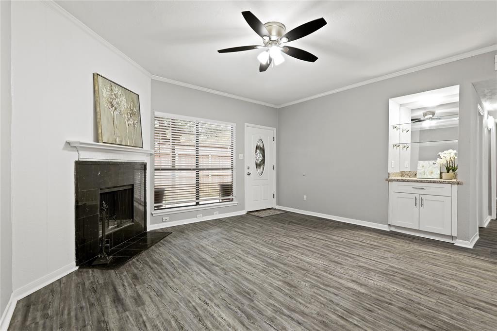 a view of an empty room with a fireplace and a window