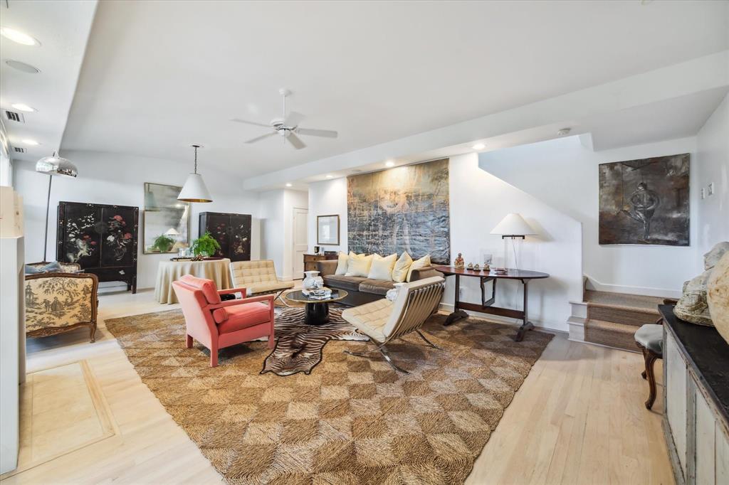 a living room with furniture large window and a fireplace