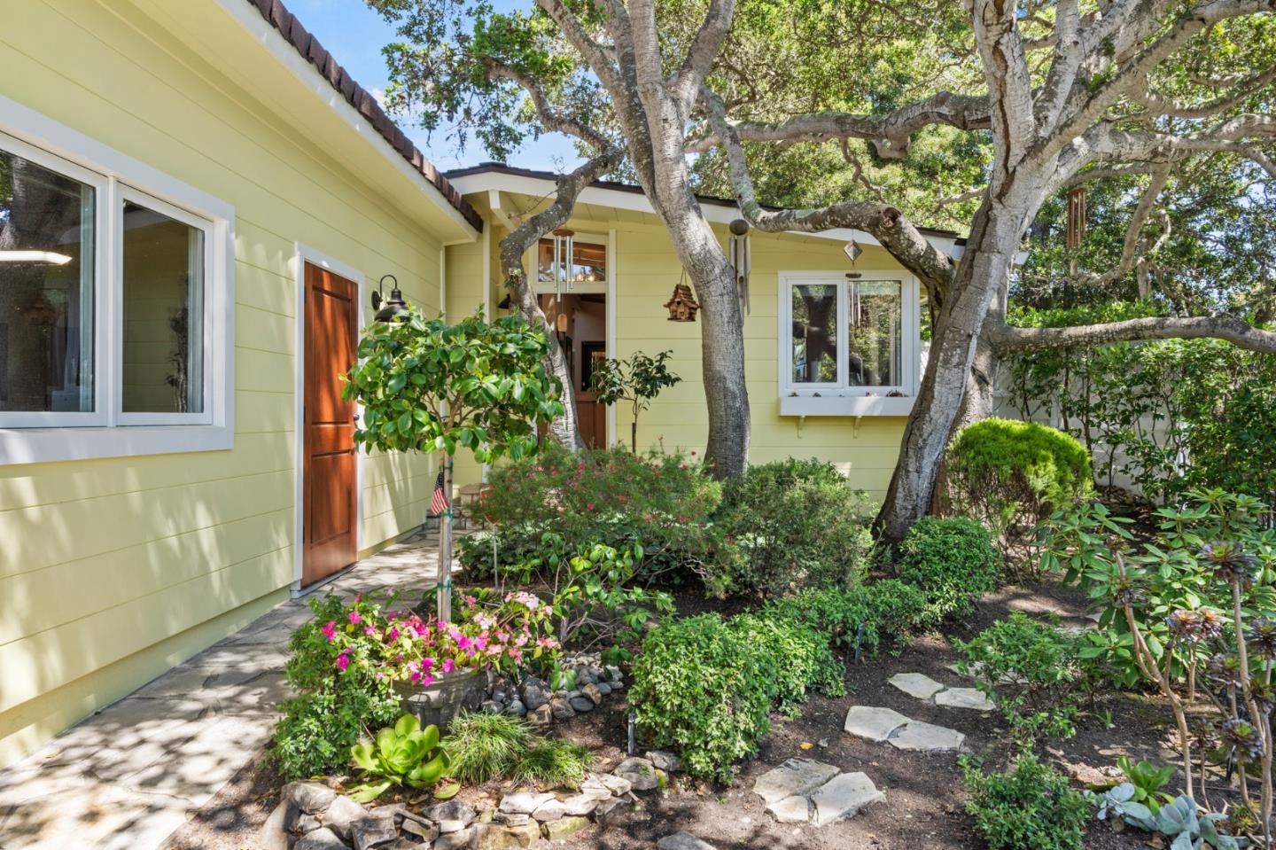 a front view of a house with garden