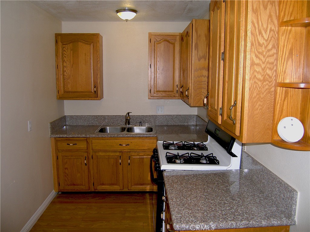 a kitchen with stainless steel appliances granite countertop a sink stove and cabinets