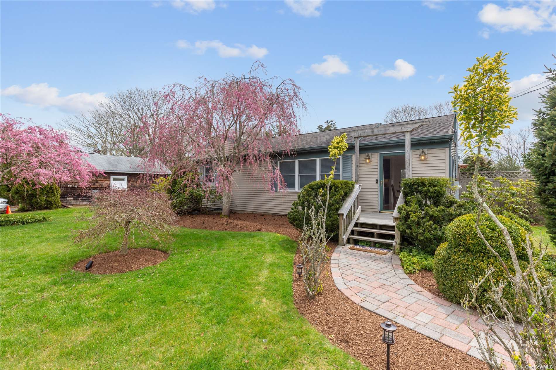 a front view of house with yard and green space