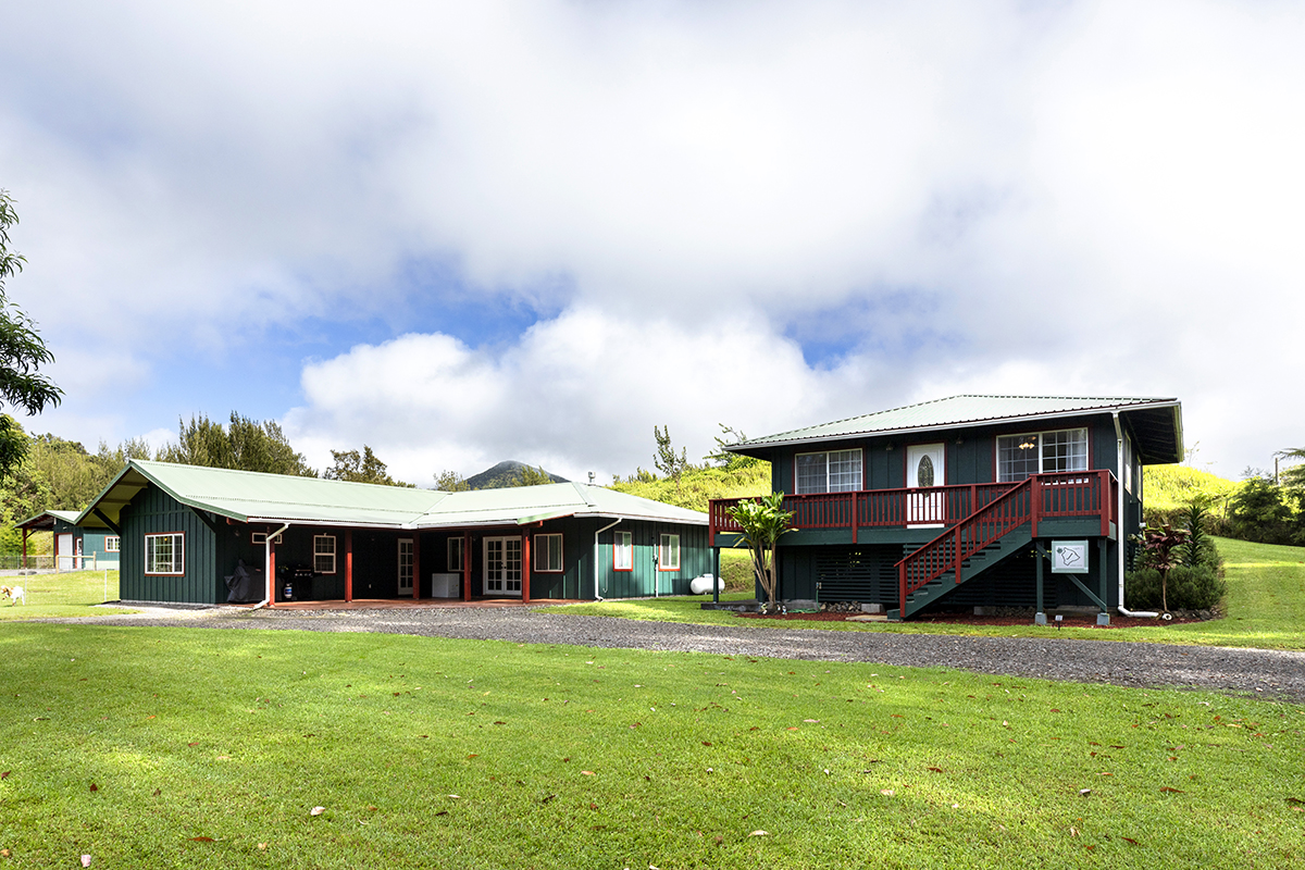 a view of a house with a backyard and a patio