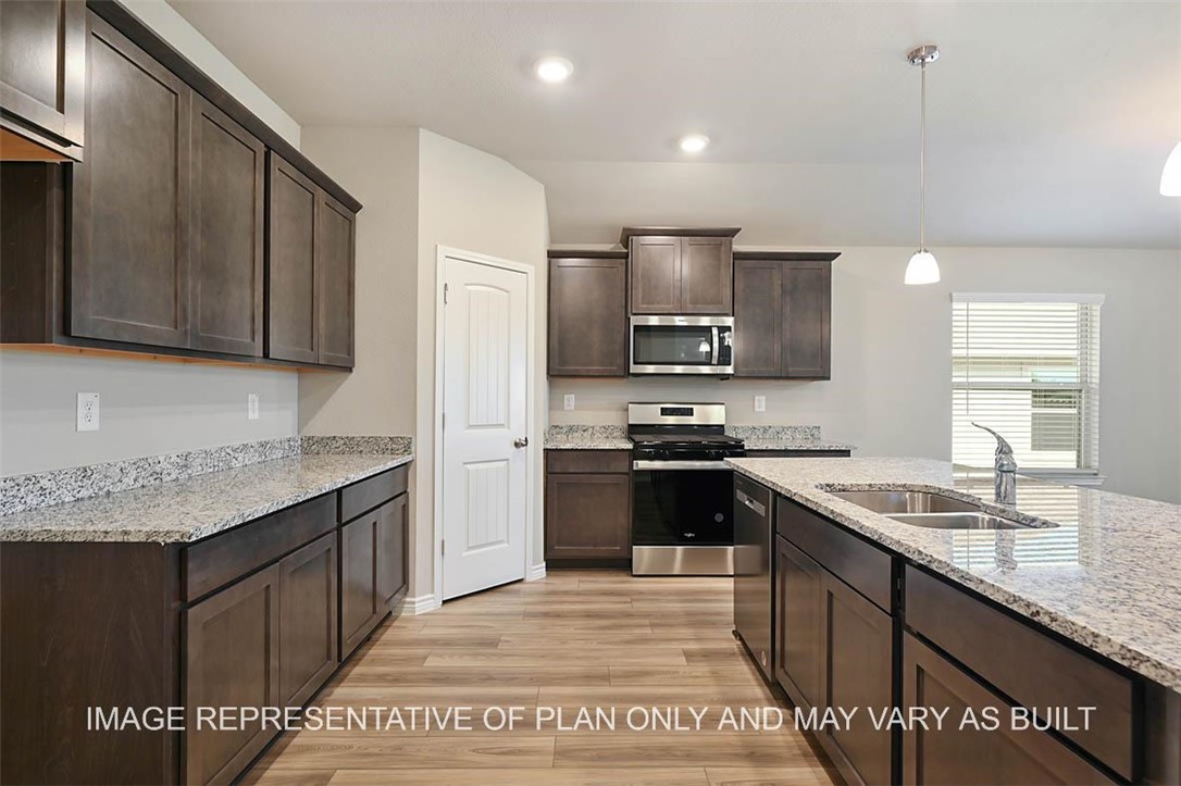 Kitchen with sink, hanging light fixtures, light h