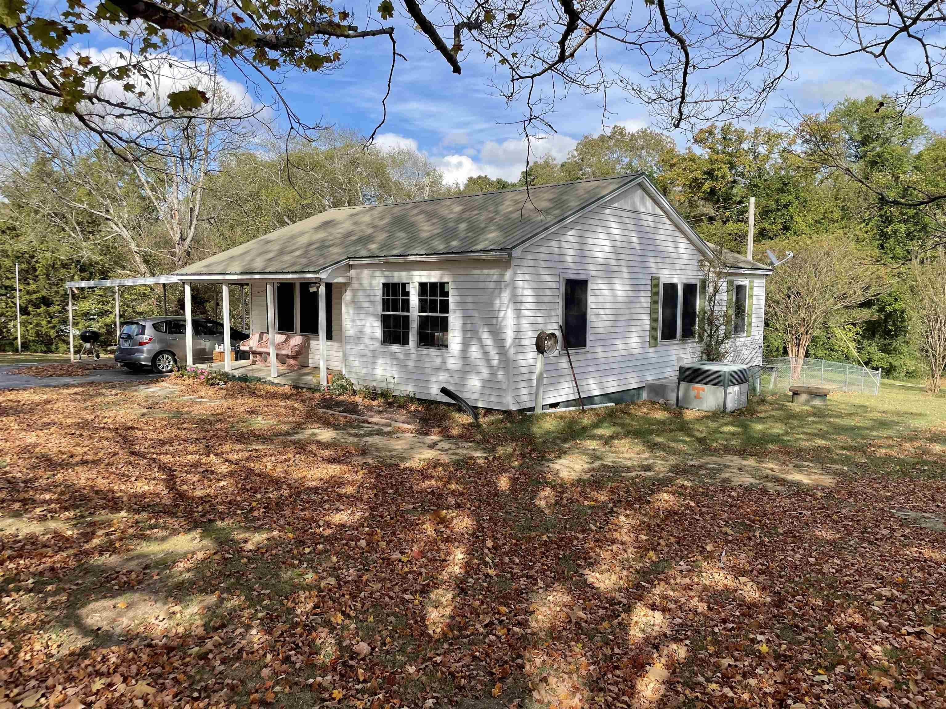 a front view of house with yard outdoor seating and barbeque oven