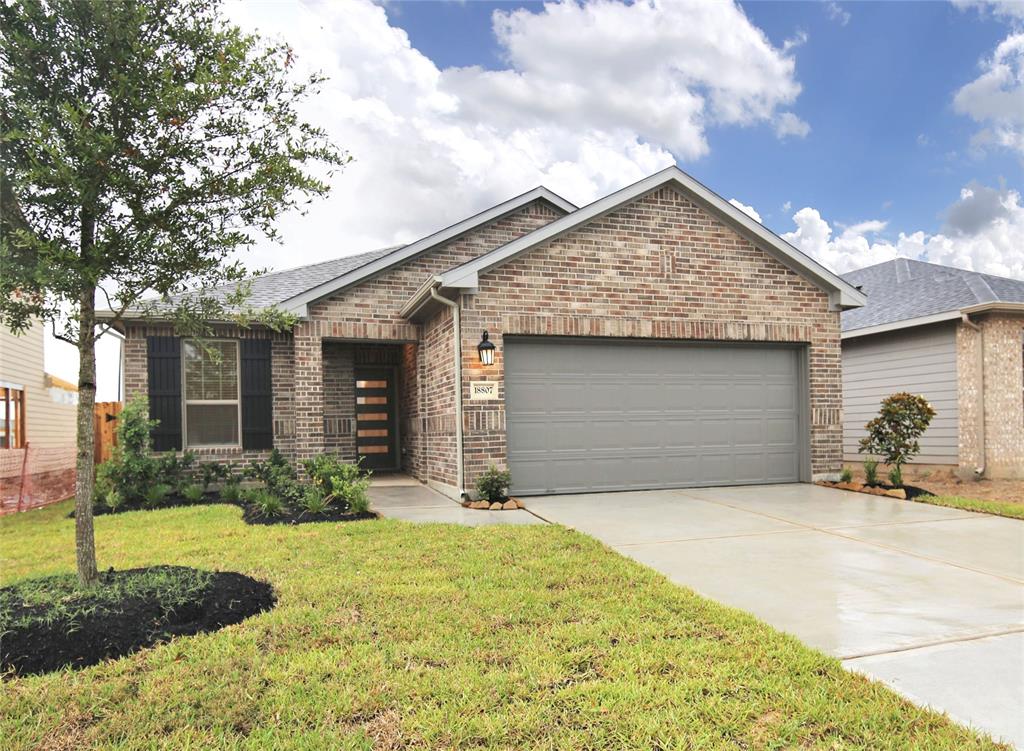 a front view of a house with yard and garage