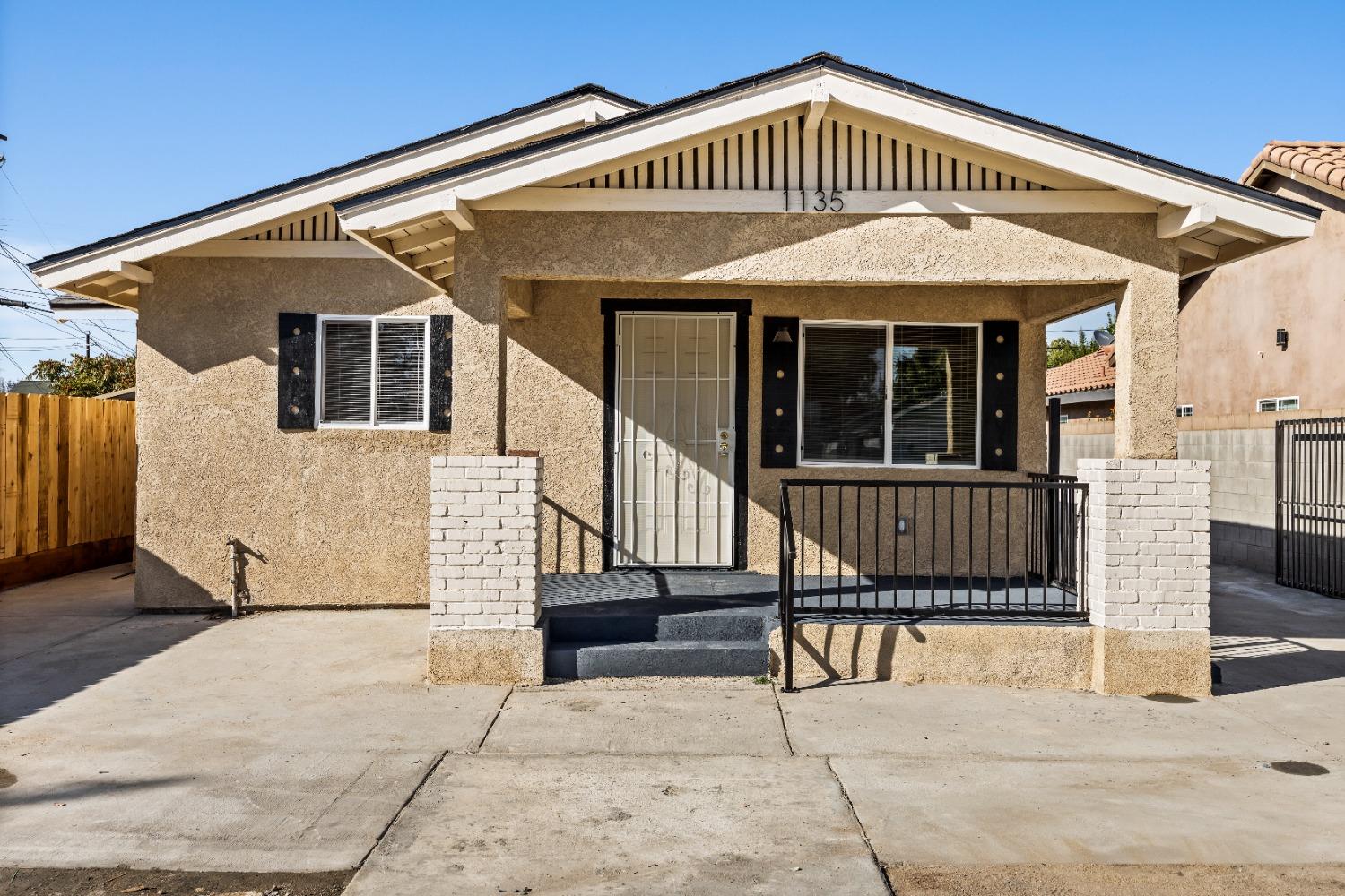 a view of a house with wooden fence