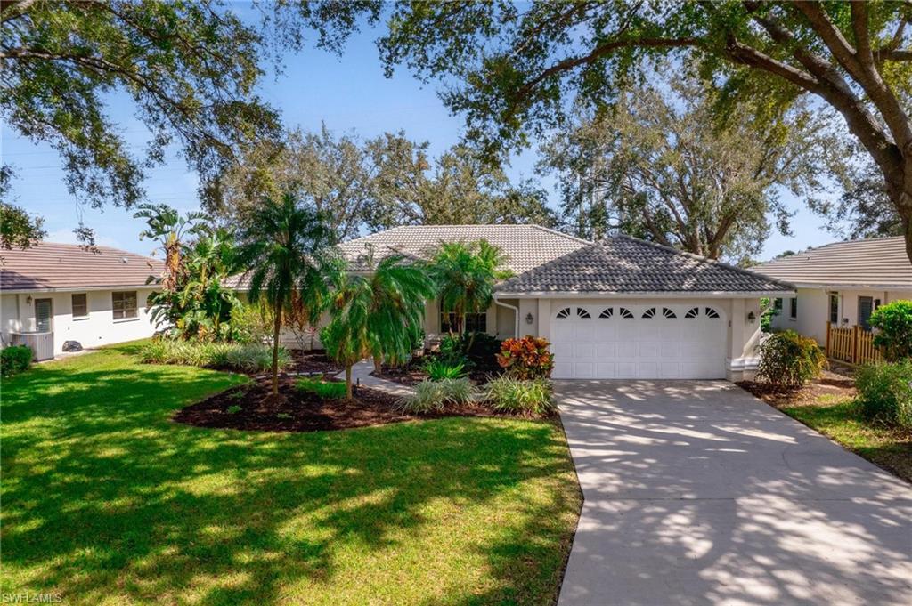 a view of a house with a yard and tree s