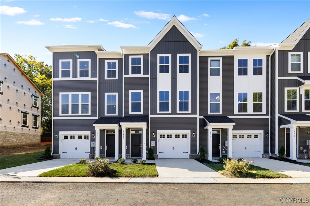 a front view of a residential apartment building with a yard