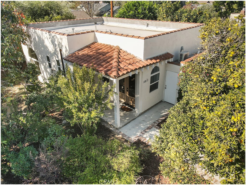 view of a house with a tree and a yard