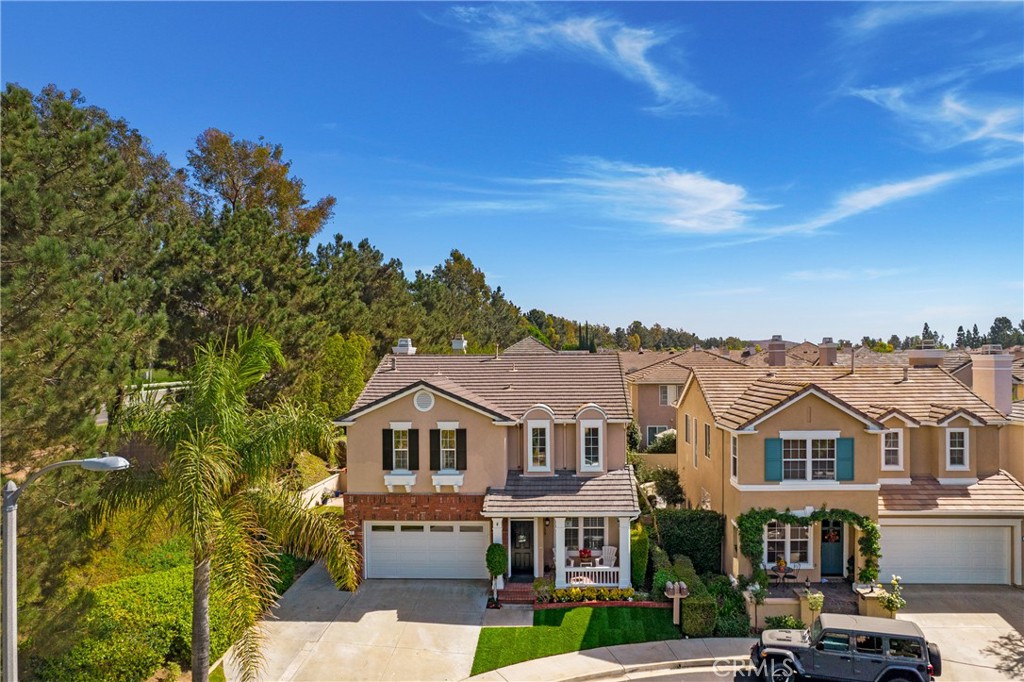 a front view of a residential houses with yard and mountain view in back