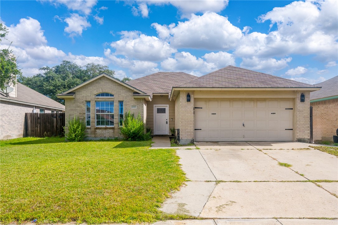 a front view of a house with a yard and garage