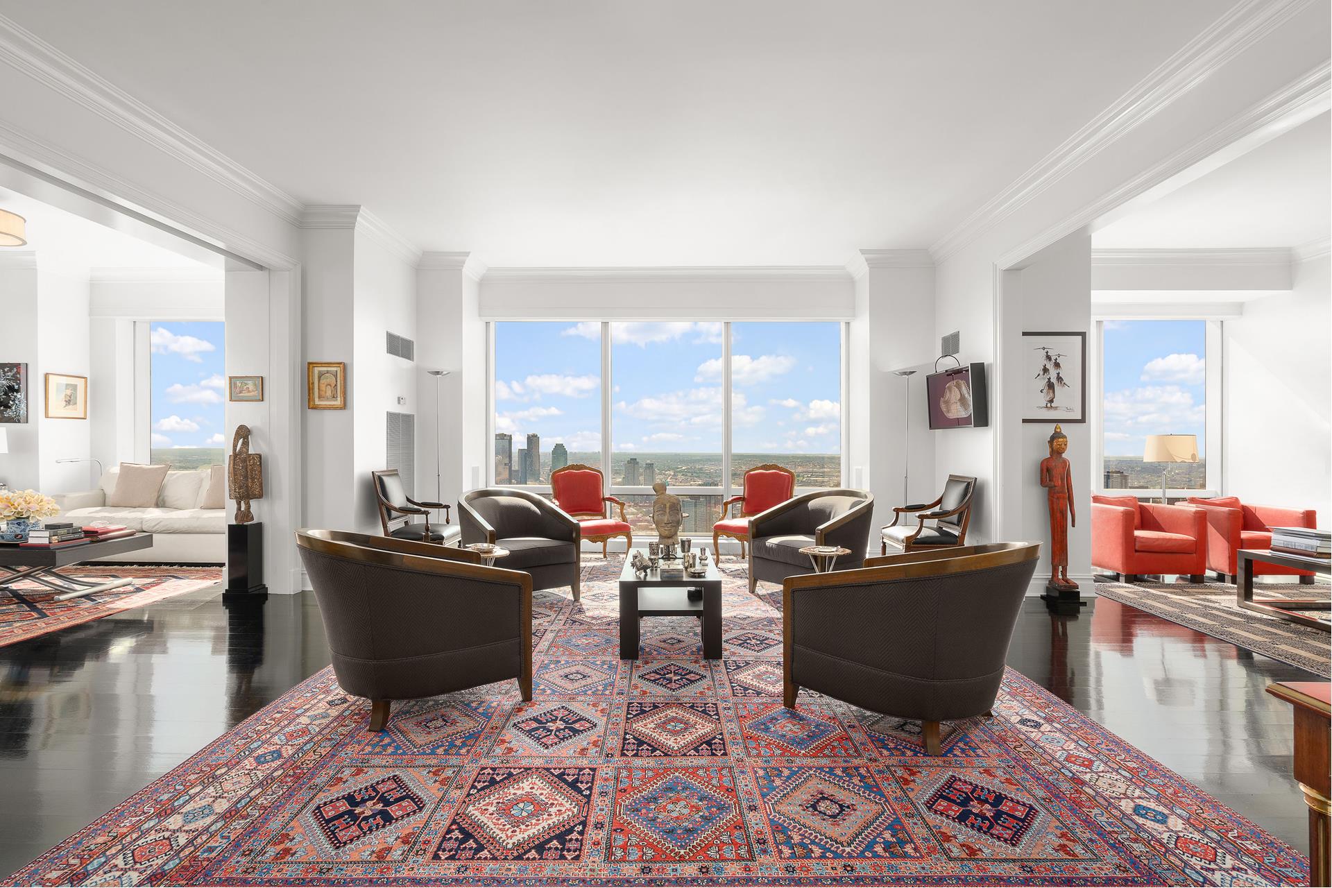 a living room with furniture large window and a table